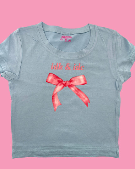 a blue t - shirt with a red bow on it