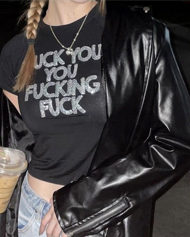 a woman in a black shirt and jacket holding a drink
