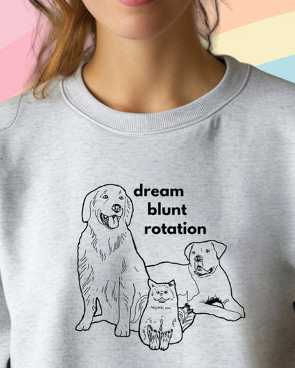 a woman wearing a sweatshirt with a picture of two dogs on it