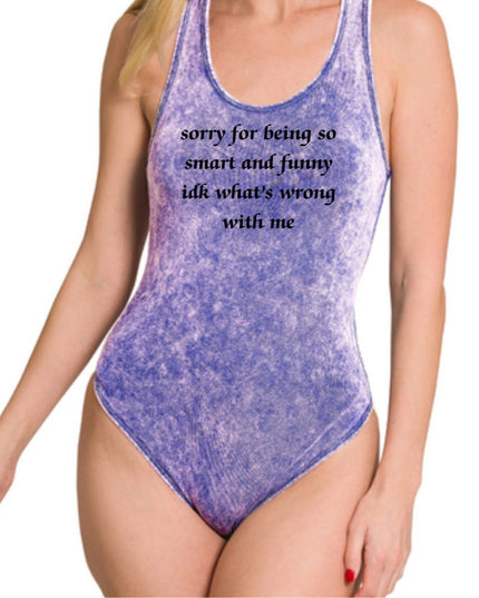 a woman wearing a purple bodysuit with a quote on it