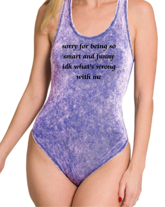 a woman wearing a purple bodysuit with a quote on it