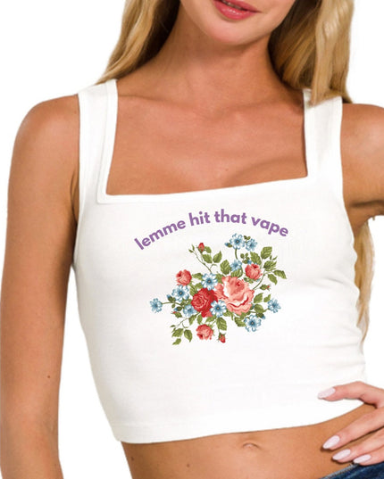 a woman wearing a white tank top with flowers on it