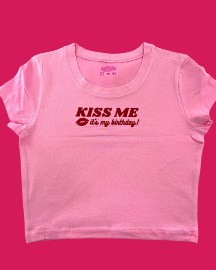 a pink t - shirt with the words kiss me on it