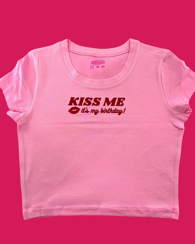 a pink t - shirt with the words kiss me on it