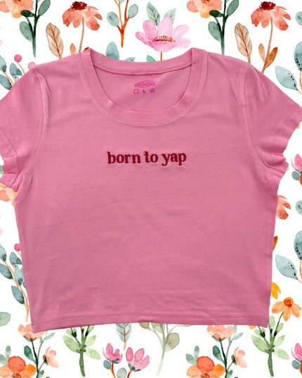a pink shirt that says born to yap on it