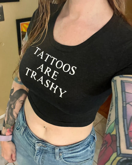 a woman wearing a black shirt with tattoos on it