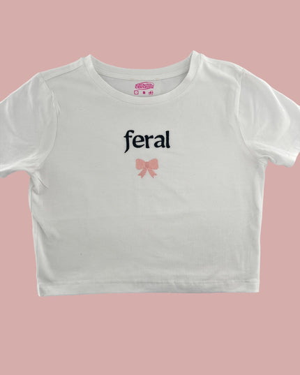 a white crop top with a pink bow on the chest