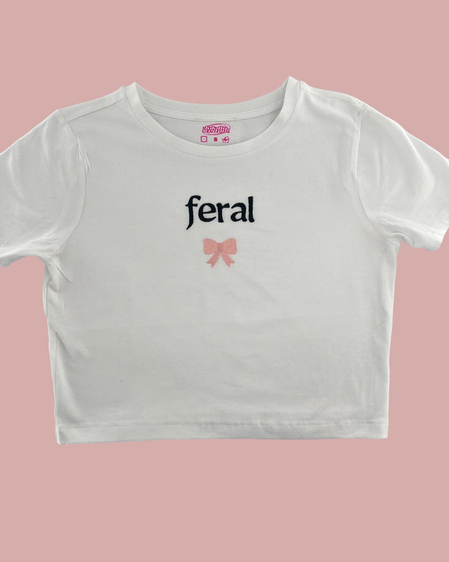 a white crop top with a pink bow on the chest