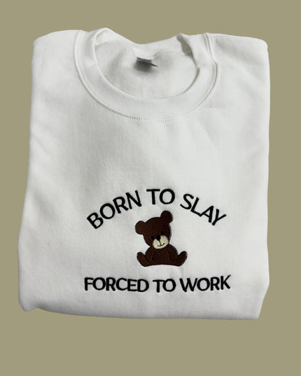 a white t - shirt with a teddy bear saying born to slay forced to