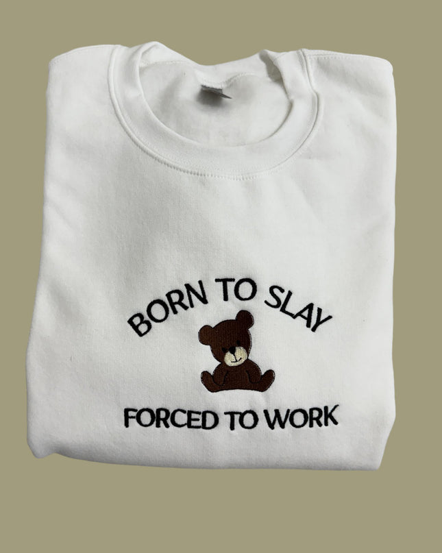 a white t - shirt with a teddy bear saying born to slay forced to