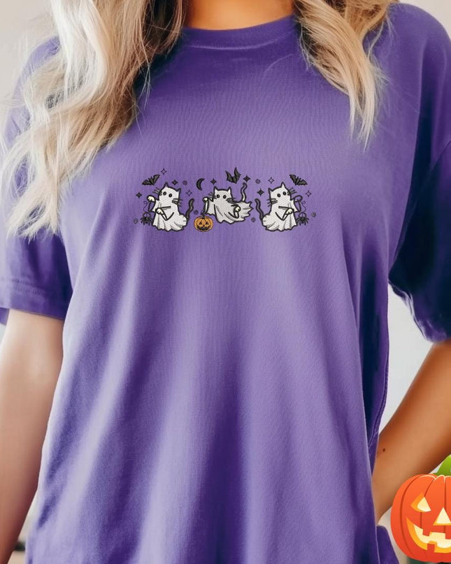 a woman wearing a purple t - shirt with a ghost on it