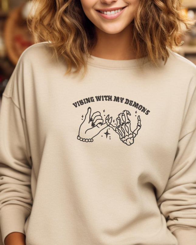 a woman wearing a sweatshirt that says wine with my hands
