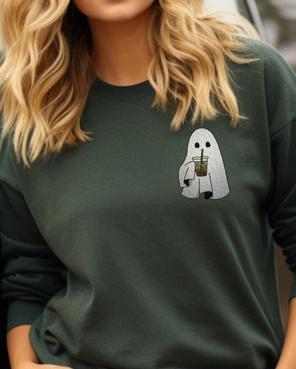 a woman wearing a green sweatshirt with a ghost on it