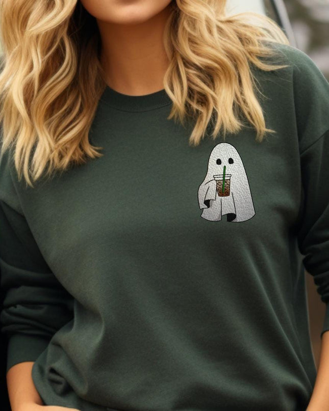 a woman wearing a green sweatshirt with a ghost on it