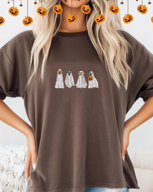 a woman wearing a brown shirt with three ghost faces on it
