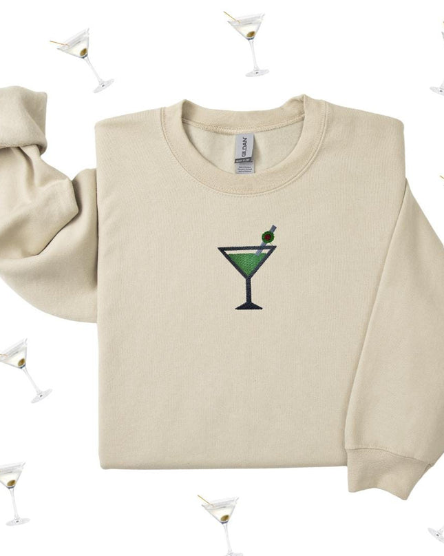 a white sweater with a green martini on it