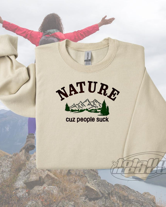 a woman standing on top of a mountain with her arms outstretched