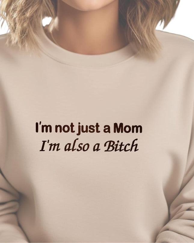 a woman wearing a sweatshirt that says i&#39;m not just a mom i &#39;