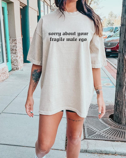 a woman standing on a sidewalk wearing a t - shirt