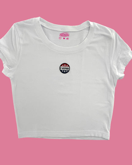 a white crop top with a pink background