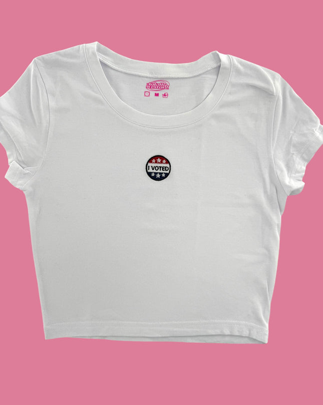 a white crop top with a pink background