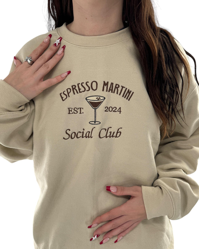 a woman wearing a sweatshirt that says espresso martini social club