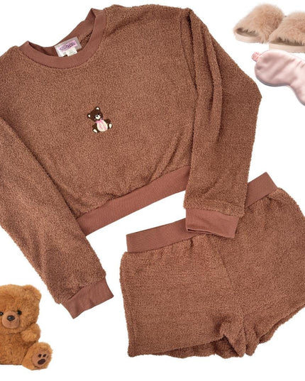 a teddy bear is next to a sweater and slippers