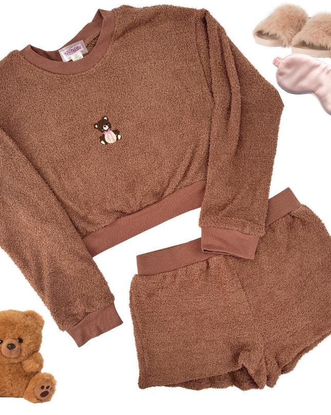 a teddy bear is next to a sweater and slippers