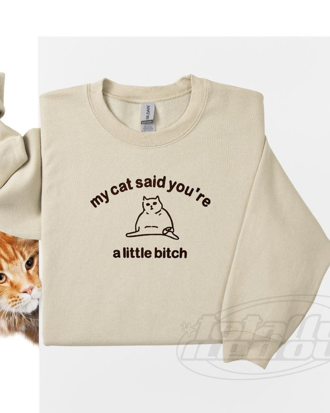 a cat wearing a sweater that says, my cat said you&#39;re a little
