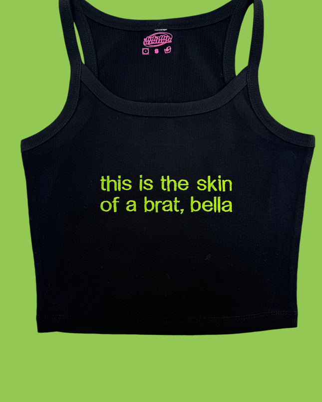 a black tank top that says, this is the skin of a brat, bel