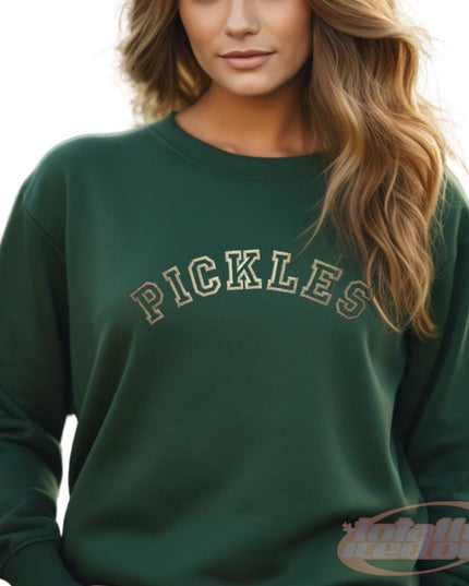 a woman wearing a green sweatshirt with the word pickles on it