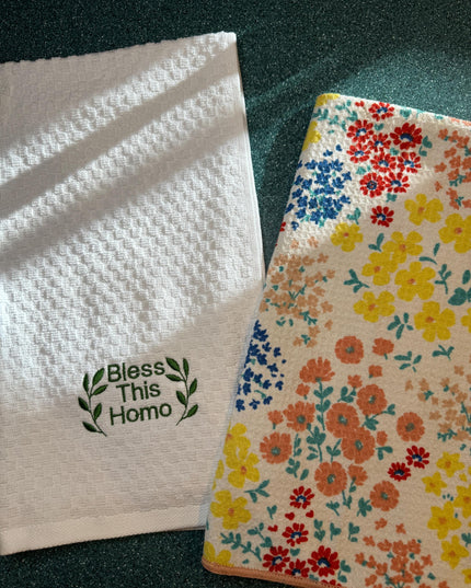 two flowered towels sitting on top of a table