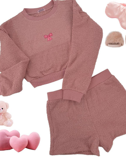 a pink outfit with a teddy bear and a pair of slippers