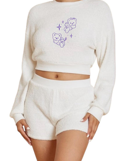 a woman wearing a white teddy bear sweater and shorts