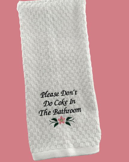 a white towel that says please don't do coke in the bathroom
