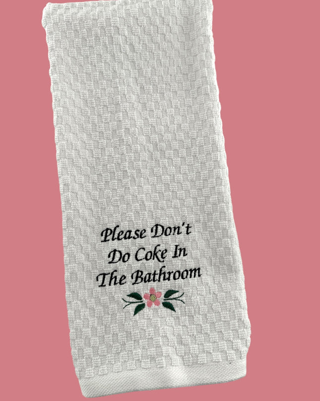 a white towel that says please don't do coke in the bathroom