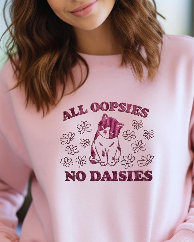 a woman wearing a pink sweatshirt that says all oppsies no daisies