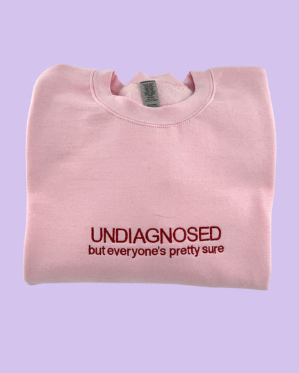 a pink t - shirt with the words undiagnosed but everyone's