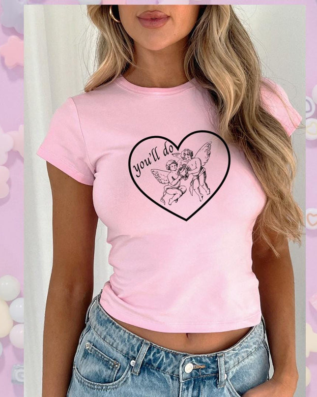a woman wearing a pink shirt with a heart on it