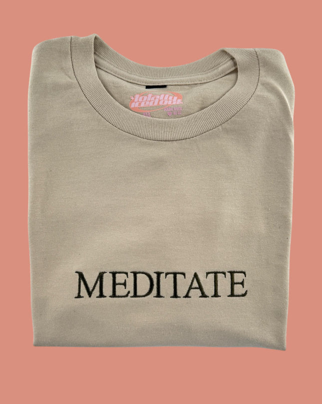 a t - shirt with the word meditate printed on it