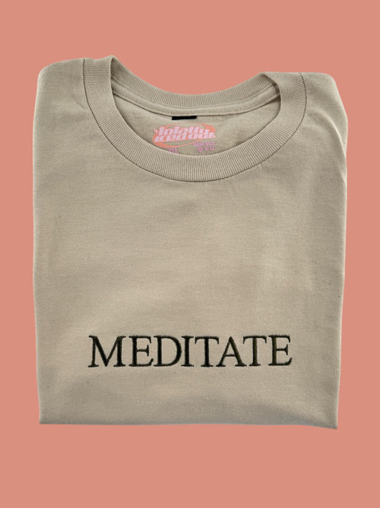 a t - shirt with the word meditate printed on it