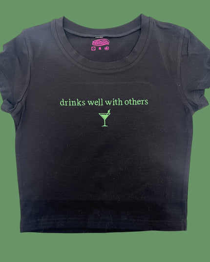 a black t - shirt with the words drinks well with others