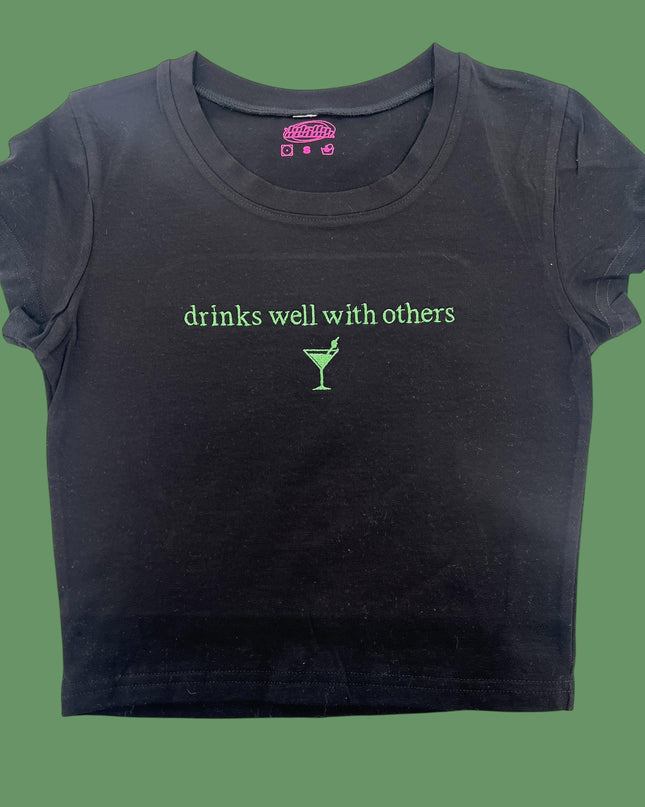 a black t - shirt with the words drinks well with others