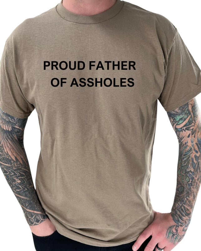 a man with a tattooed arm wearing a t - shirt that says proud father of