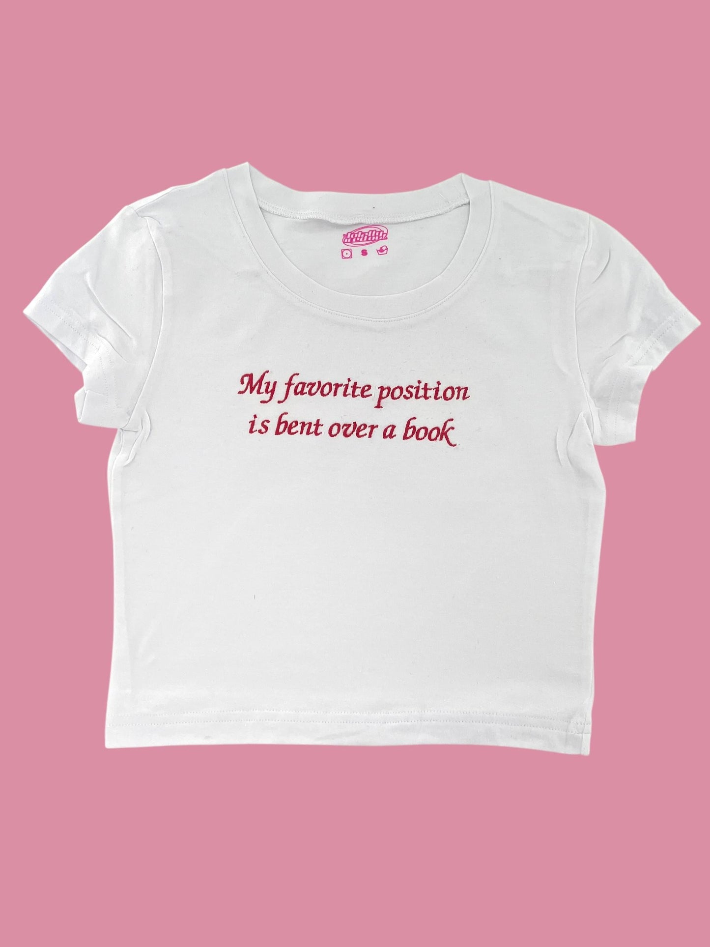 a white t - shirt that says, my favorite position is bent over a book