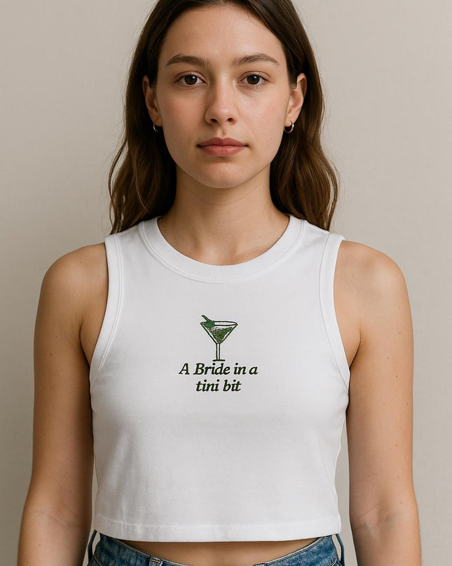 a woman wearing a white crop top with a green logo