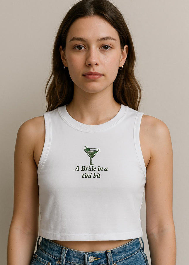 a woman wearing a white crop top with a green logo