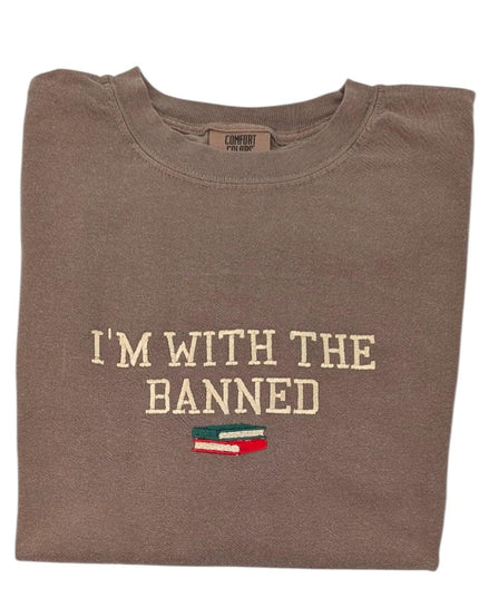 a brown t - shirt that says i'm with the banned