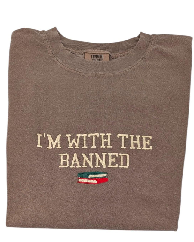 a brown t - shirt that says i'm with the banned