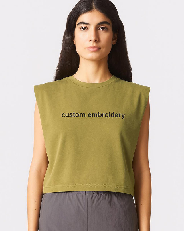 a woman wearing a green shirt with the words custom embroidery on it